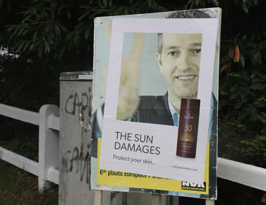 サンプロテクト（Gerard's）の屋外広告。太陽によって色褪せたポスターに貼られた広告。こうなる前に、という事でしょうね。＜ベルギー＞